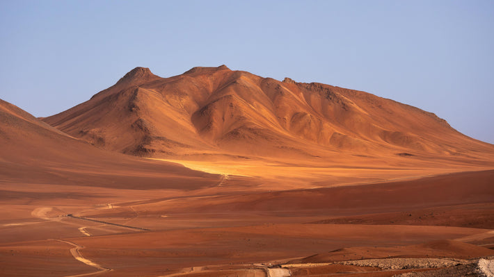Remote desert mountain landscape with clear skies, ideal for solar or wind energy infrastructure deployment
