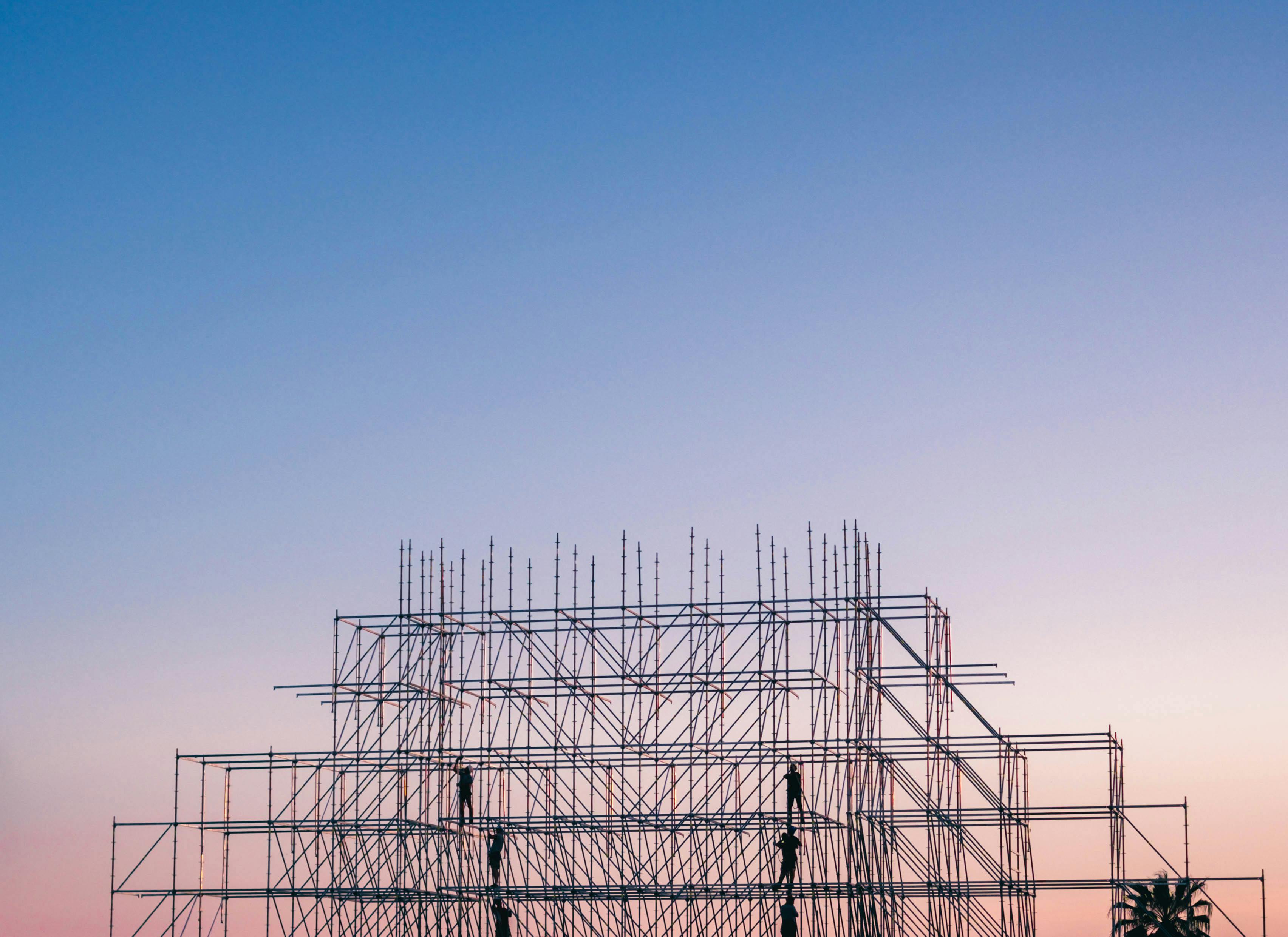 Scaffolding structure at sunset representing the foundation of smart infrastructure and Gletscher Energy’s role in powering tomorrow’s energy ecosystems.