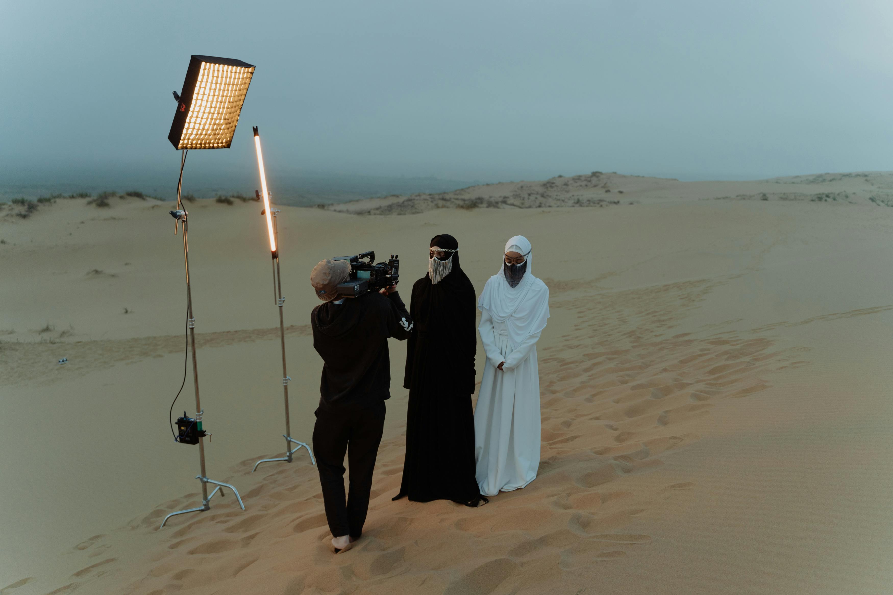 Filming crew powering lights and camera equipment in a remote desert setting—demonstrating Gletscher Energy’s off-grid portable power solutions for media professionals in extreme environments.