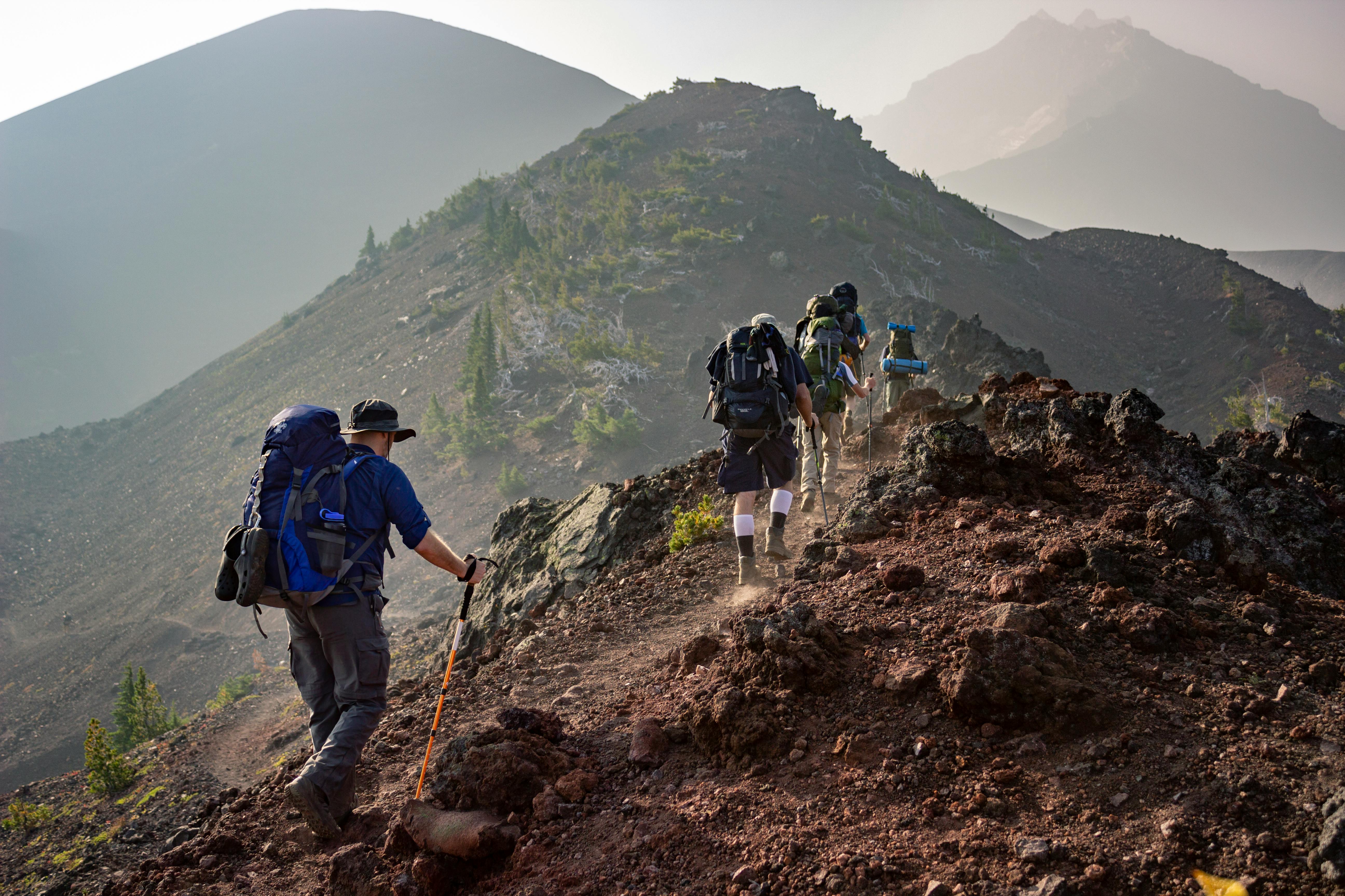 Expedition hikers trekking across a volcanic ridge—ideal use case for Gletscher Energy’s lightweight powerbanks and off-grid solar charging solutions for extreme outdoor environments.